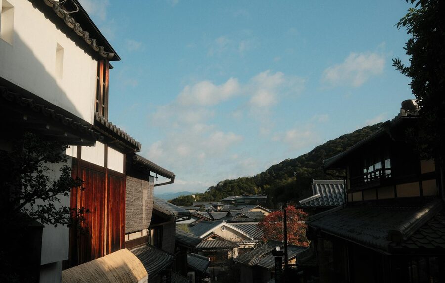 Narrow traditional Kyoto street with wooden facades in autumn