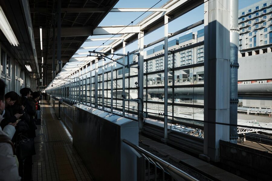 Kyoto Station platform with passengers waiting for a train in bright daylight