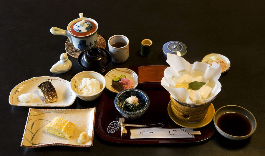 Traditional Japanese ryokan breakfast with grilled salmon, rice, miso soup and pickles