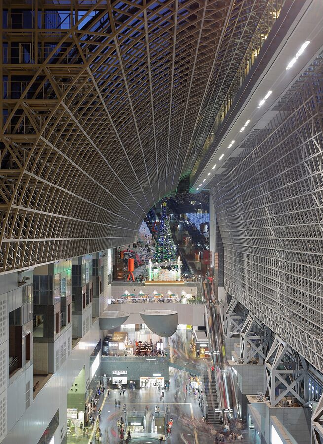Kyoto Station's soaring glass-and-steel atrium with escalators rising into the upper floors
